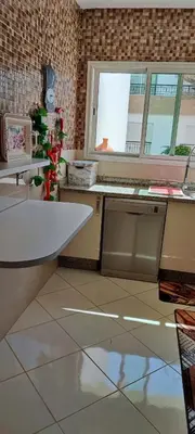 a kitchen with a table and a window and a counter at Al yakoute in Mansouria
