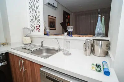 a kitchen with a sink and a counter top at Domaine d'Anfa - Luxe & Mer in Casablanca