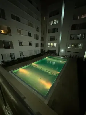 an empty swimming pool in a building at night at Plage manesmann in Mohammedia