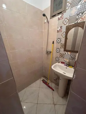 a small bathroom with a sink and a shower at Appartement meublé calme et chaleureuse in Temara