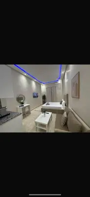 a living room with a couch and a table at Bouznika tour House in Bouznika