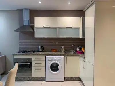 a kitchen with a washing machine and a stove at Chic & secure in Casablanca