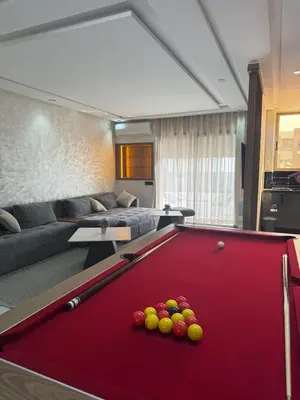a living room with a pool table with balls on it at Appartement Luxueux Mer & Piscine in Mansouria