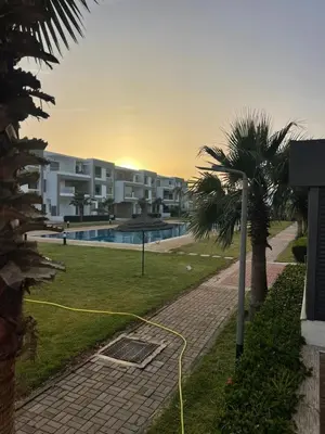 a yellow hose is connected to a building at Appartement Luxueux Mer & Piscine in Mansouria