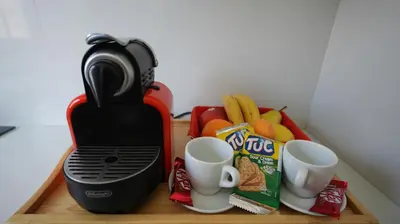 a coffee maker with two cups and snacks on a table at Panoramique Studio a casablanca in Casablanca