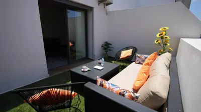 a living room with a couch and a table on a balcony at Panoramique Studio a casablanca in Casablanca