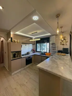 a large kitchen with a large marble counter top at Comfortable apartment temara in Temara