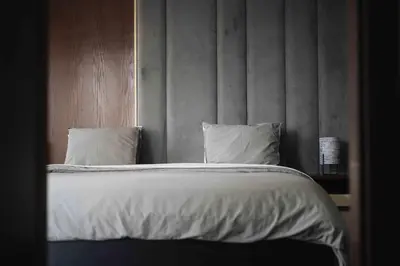 a bedroom with a bed with white sheets and pillows at Luxury Villa Jack Beach Resort Pool & Seaview in Tamaris