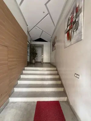 a hallway with stairs with a red rug at Studio les princesses in Casablanca