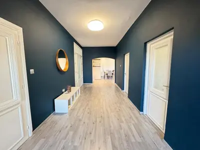 an empty hallway with blue walls and wooden floors at private villa with swimming pool in Rabat