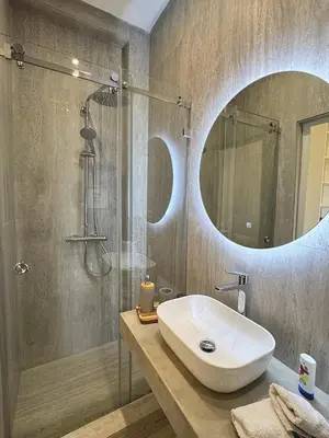 a bathroom with a sink and a shower with a mirror at private villa with swimming pool in Rabat