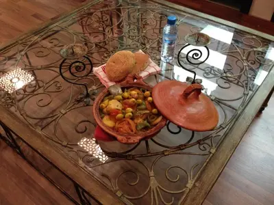 a glass table with a basket of food on it at Rabat Apartments in Rabat