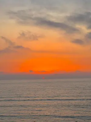 an orange sunset over the ocean with the sky at Villa 1 Corniche, Seaside Stay at Carrousel Mall, Walk Everywhere in Rabat