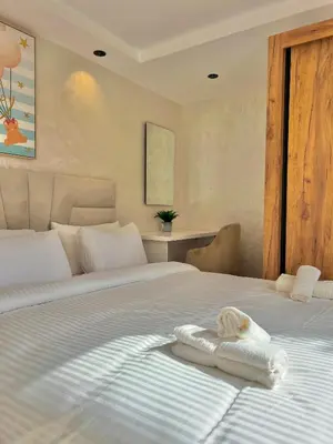 a bedroom with a bed with a towel on it at C2, Modern Charm apartment Facing Carrousel with Ocean View in Rabat