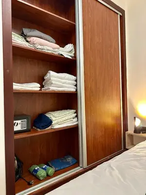 a room with a closet with towels and a bed at Appartement chic - Princesses in Casablanca