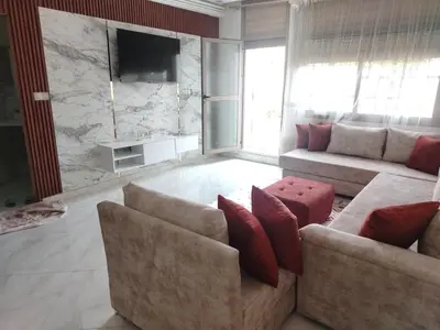a living room with two couches and a television at Charmant appartement à Casablanca Près tram & gare in Casablanca