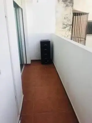a hallway with a room with white walls and a room with aartment at Chambre zuiten in Casablanca
