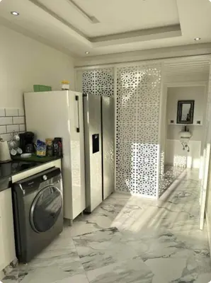a kitchen with a refrigerator and a washing machine at Rabat Agdal apartment in Rabat