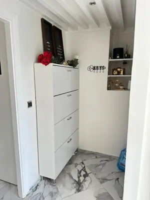 a white dresser in a room with a wall at Rabat Agdal apartment in Rabat