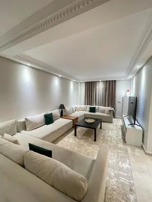 a living room with two couches and a tv at 2-bedroom duplex for rent in Temara