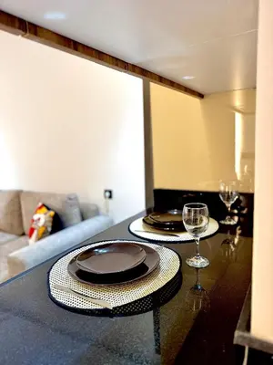 a table with two plates and wine glasses on it at ARENA 41- Maarif in Casablanca