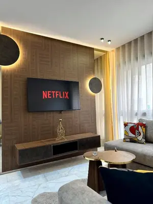 a living room with a television on a wall at ARENA 41- Maarif in Casablanca