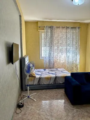 a room with a bed and a couch and a window at Dar Raciki Elikya in Rabat