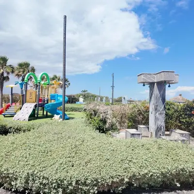 a playground with a slide in a park at Appartement Tamaris avec piscine et plage privée in Casablanca