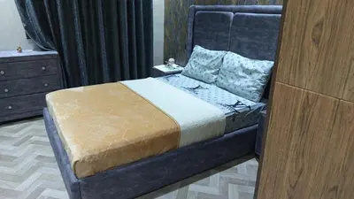 a bedroom with a bed and a dresser at Appartement ainsbaa in Casablanca
