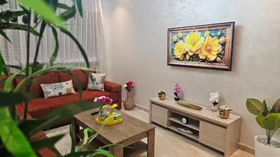 a living room with a couch and a painting of flowers at Beautiful 3-Bedroom Apartment in Maarif, Spacious Living for Families, Groups & Business Travelers in Casablanca