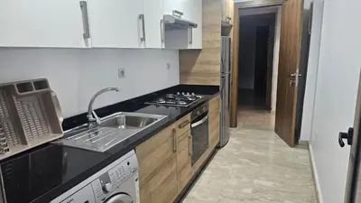 a kitchen with a sink and a stove at Beautiful 3-Bedroom Apartment in Maarif, Spacious Living for Families, Groups & Business Travelers in Casablanca