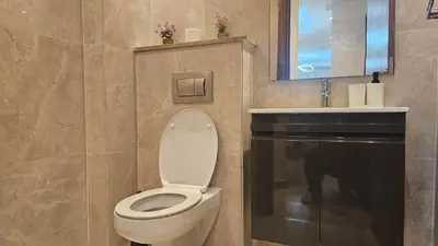 a bathroom with a toilet and a sink at Beautiful 3-Bedroom Apartment in Maarif, Spacious Living for Families, Groups & Business Travelers in Casablanca