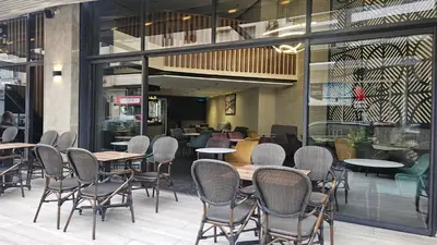 a dining room with tables and chairs in a restaurant at Beautiful 3-Bedroom Apartment in Maarif, Spacious Living for Families, Groups & Business Travelers in Casablanca