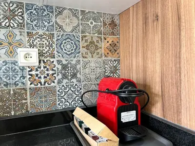 a kitchen with a toaster and a tile wall at Elegant Lateral Beachfront Family Stay in Casablanca