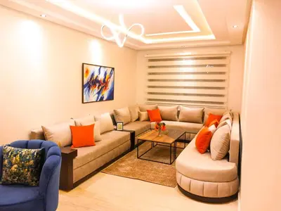 a living room with a couch and two chairs at Elegant Lateral Beachfront Family Stay in Casablanca