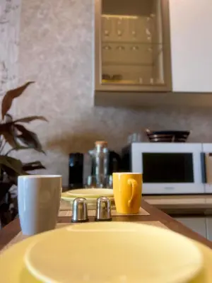 a bathroom sink with two cups and a microwave at Rafina in Casablanca