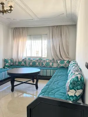 a living room with a couch and a table at Appartement Jamila in Rabat