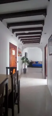 a living room with a table and a couch at Appartement Jamila in Rabat