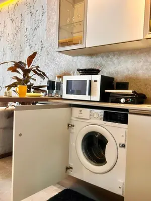 a kitchen with a washing machine and a microwave at Rafina in Casablanca