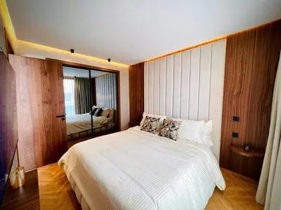 a bedroom with a large white bed with a mirror at Rafina in Casablanca
