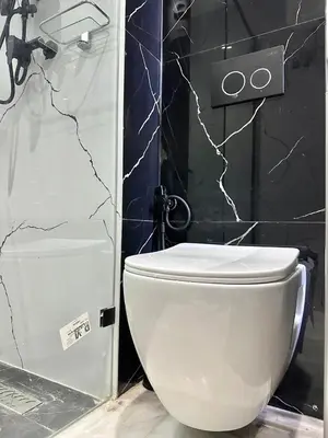 a bathroom with a white toilet and a shower at Cosy Central Studio with balcony Maarif - Near Twin Center in Casablanca