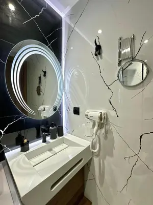 a bathroom with a white sink and a mirror at Cosy Central Studio with balcony Maarif - Near Twin Center in Casablanca