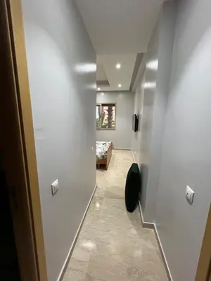 a hallway with white walls and a room at Tamaris Green in Casablanca