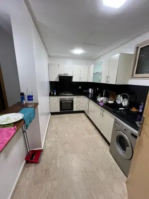 a kitchen with white cabinets and a washer at Tamaris Green in Casablanca