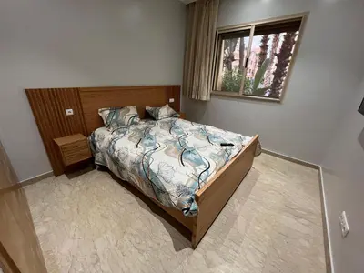a bedroom with a bed and a window at Tamaris Green in Casablanca