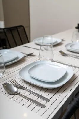 a table with white plates and silverware on it at NESK STAY Gauthier in Casablanca