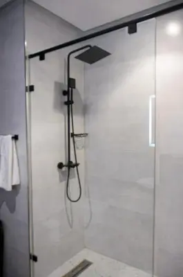 a shower with a glass door in a bathroom at Villa 130 Spacieuse 4 chambres dar bouazza proche plage in Casablanca