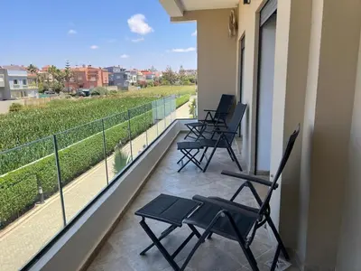 four chairs sitting on a balcony with a view at Relaxing Stay 3 Pools & Beach in Sidi Rahal