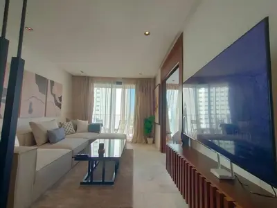 a living room with a couch and a large tv at Beautiful Apartment, Great Location, Fiber Optic in Casablanca