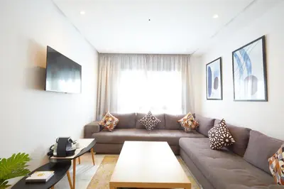 a living room with a couch and a table at Beautiful 1 Bedroom in the Center of Casablanca in Casablanca